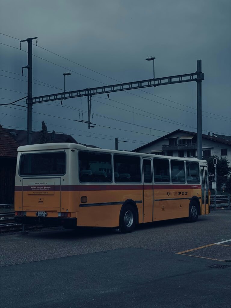 A yellow and white bus parked in a parking lot